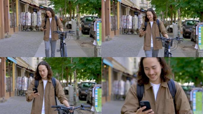通勤者推着他的自行车并在城市街道上使用电话