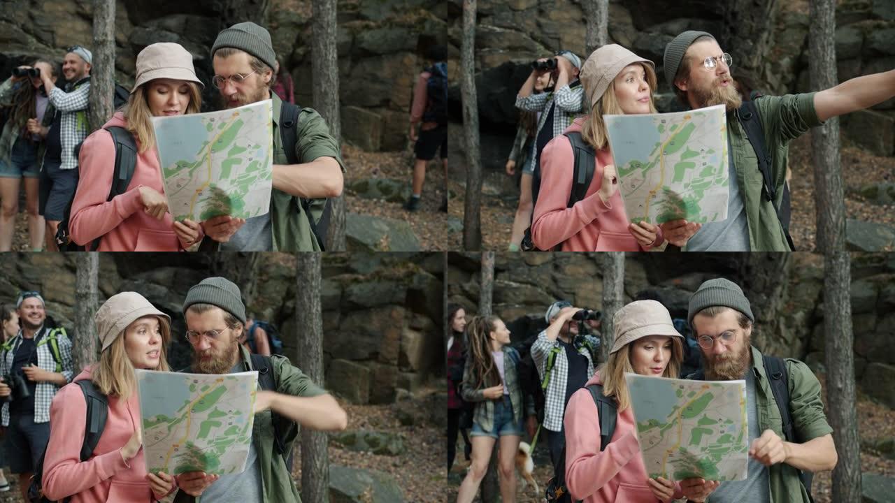 游客计划旅行，看着地图打手势，一起站在森林里说话