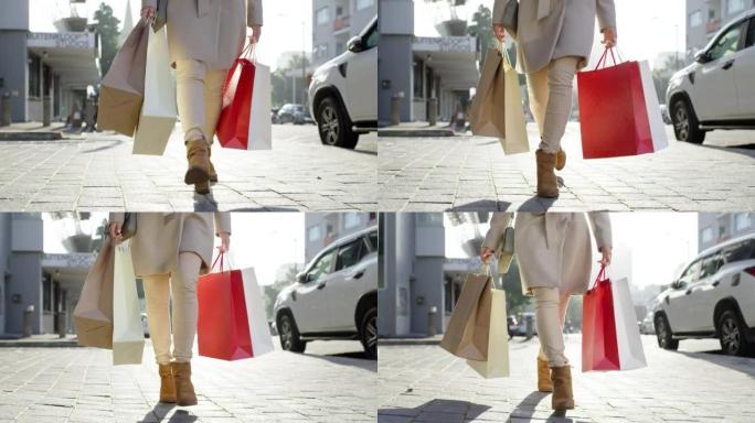 购物，零售和金钱，一个有钱的女人在去商店，购物中心或商店购物后在城市里散步。女性客户或消费者在城市背