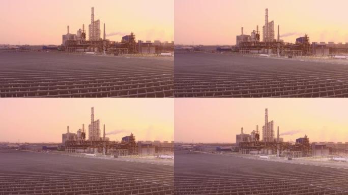 带日落的炼油厂和太阳能发电站的鸟瞰图