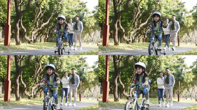 亚洲小女孩在户外骑自行车