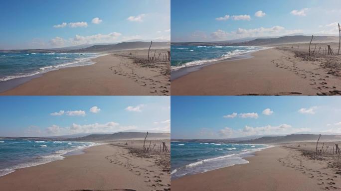 意大利撒丁岛海滩上波浪滚滚的景色。