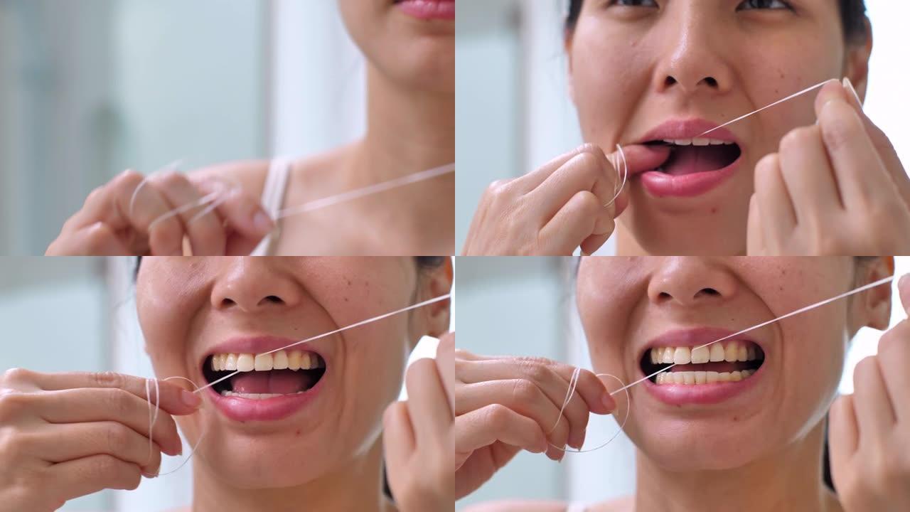 女人用牙线洁牙，同时从齿间取出剩余的食物