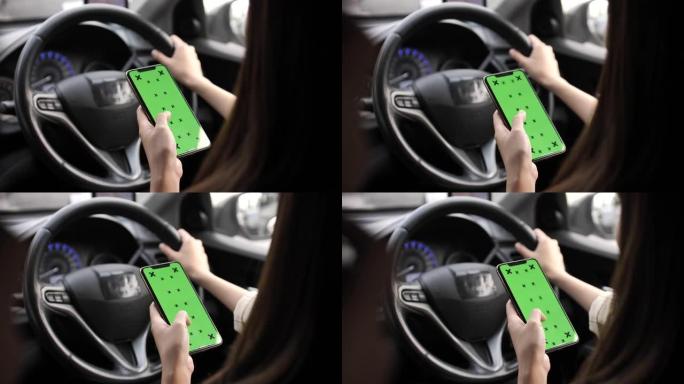 手握智能手机与绿色空白屏幕在电动车方向