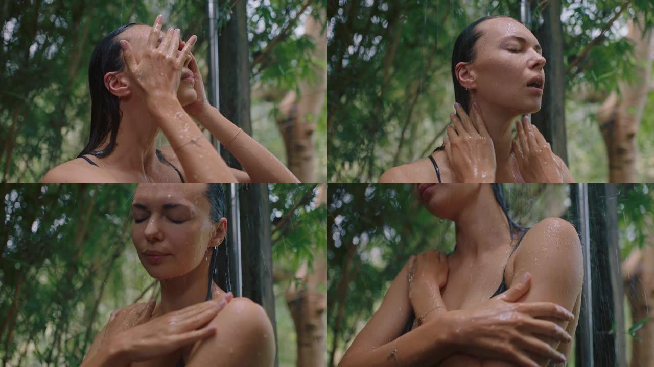 迷人的女人在淋浴穿着比基尼洗身体清洁皮肤与清爽的水享受自然美容温泉在大自然的户外淋浴