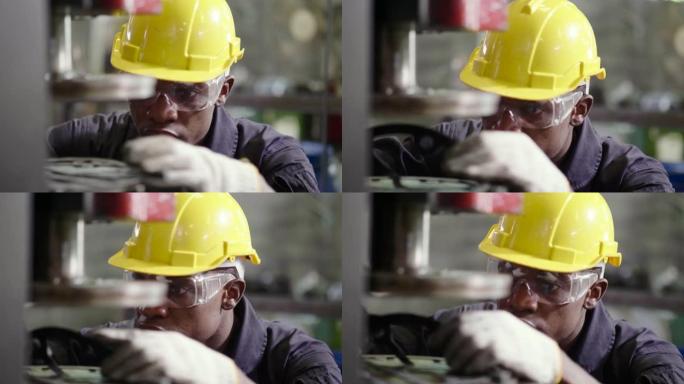 戴着安全帽的工厂工人在金属钢上工作