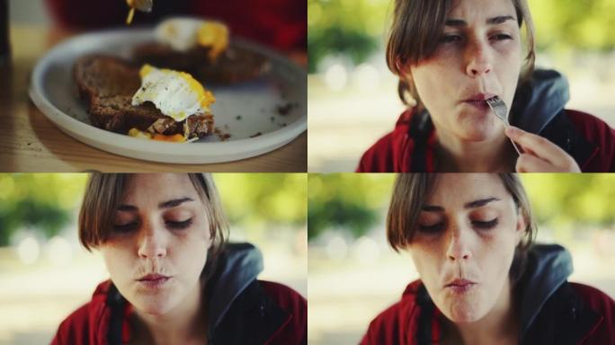 4k视频片段，一个美丽的年轻女子在外面享用早餐