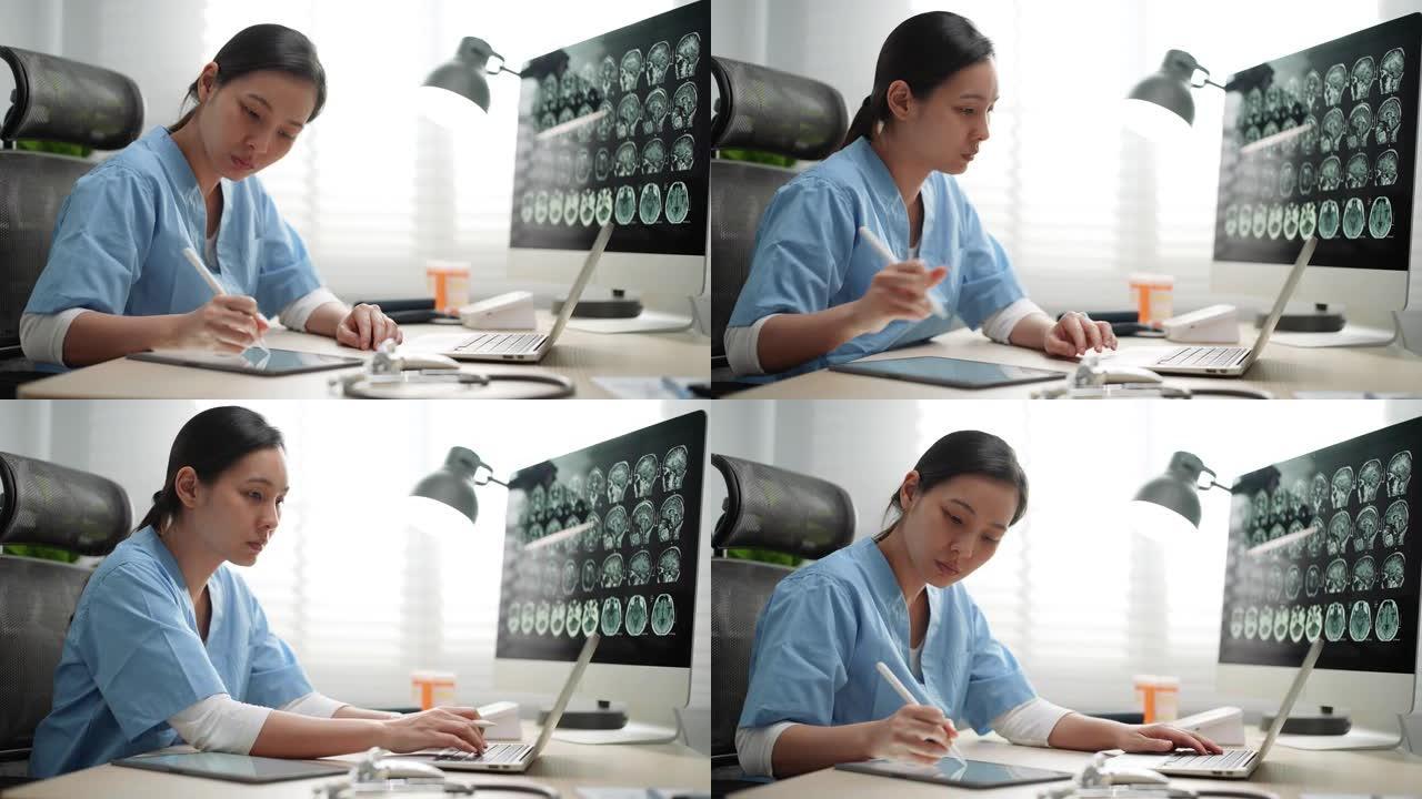 年轻的亚洲医生在医院使用笔记本电脑