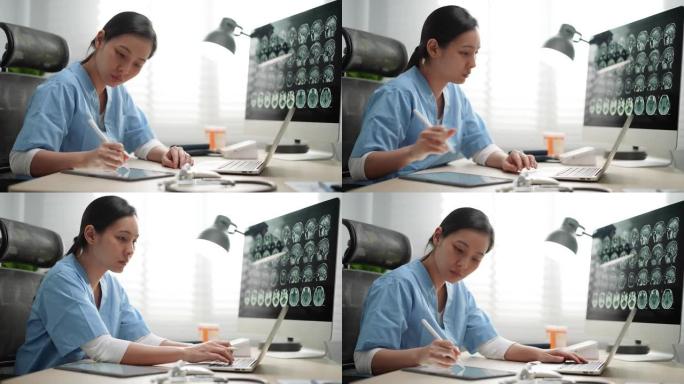 年轻的亚洲医生在医院使用笔记本电脑