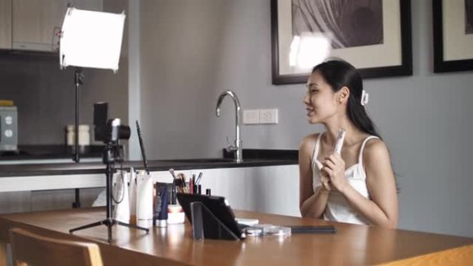 年轻美丽的亚洲女性和专业美容化妆师vlogger