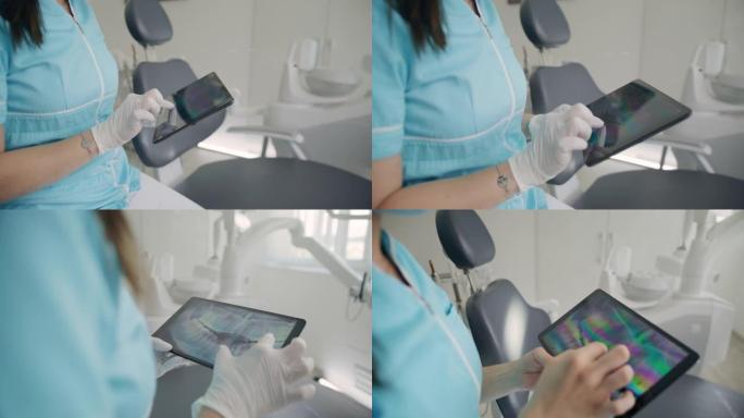 MS牙医在数字平板电脑上观察人类牙齿的x射线