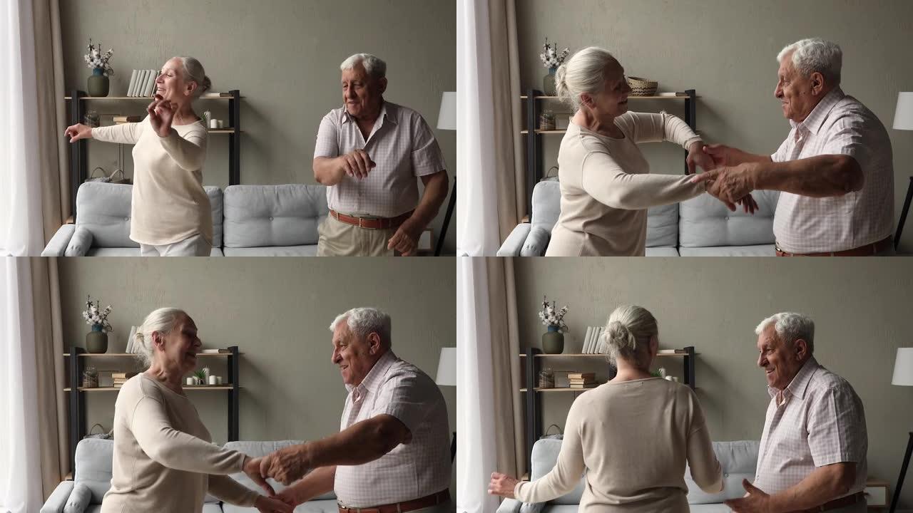 无忧无虑的健康退休人员配偶在客厅手牵手跳舞