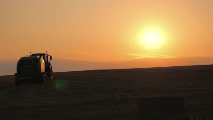 日落时在田野上行驶的拖拉机SLO MO