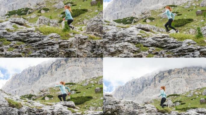 专注的运动女性在陡峭的落基山上坡的人迹罕至的道路上奔跑