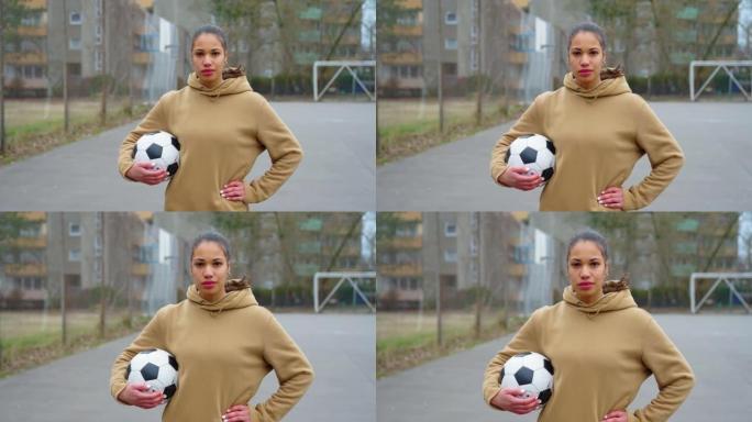 站在运动场上自信的女子足球运动员的肖像