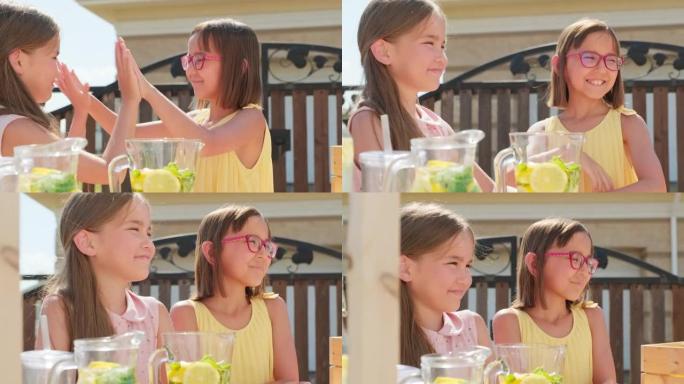 快乐的女孩在夏日卖柠檬水