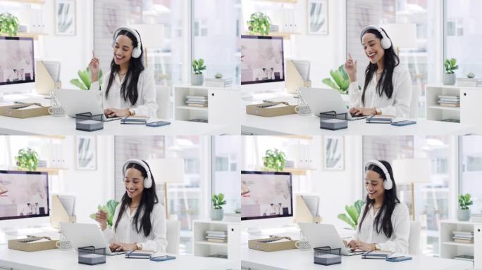 一名年轻女商人在现代办公室使用笔记本电脑和耳机的4k视频片段