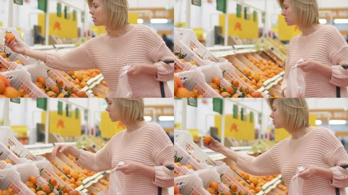 一个40多岁可爱的女性买家和采摘橙色水果架架室内超市。无忧无虑的女孩寻找牵手生物素食自然食品。绿色杂