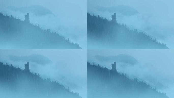 薄雾雨中山上的城堡塔