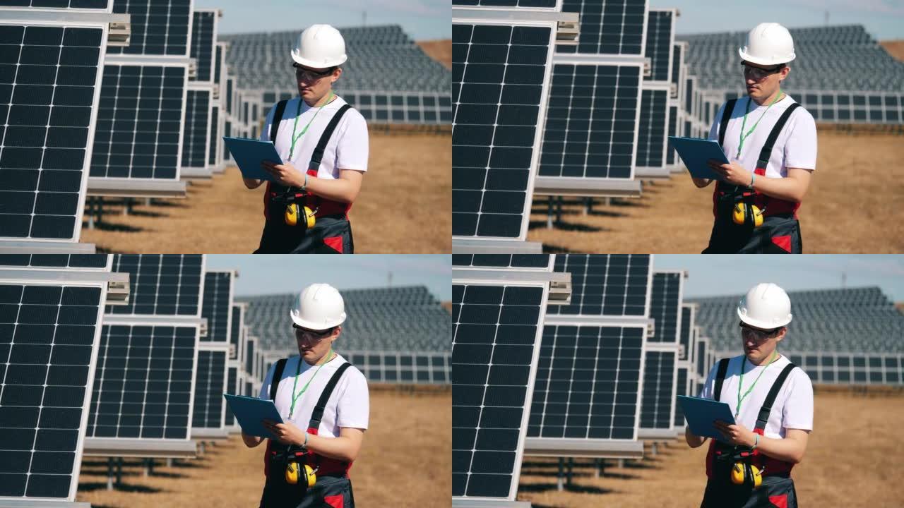 男工程师正在检查太阳能电池。可再生能源、太阳能发电厂、绿色电力概念。