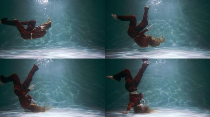 令人惊叹的电影镜头，年轻美丽的舞者在水下慢动作下颠倒了现代舞蹈动作。