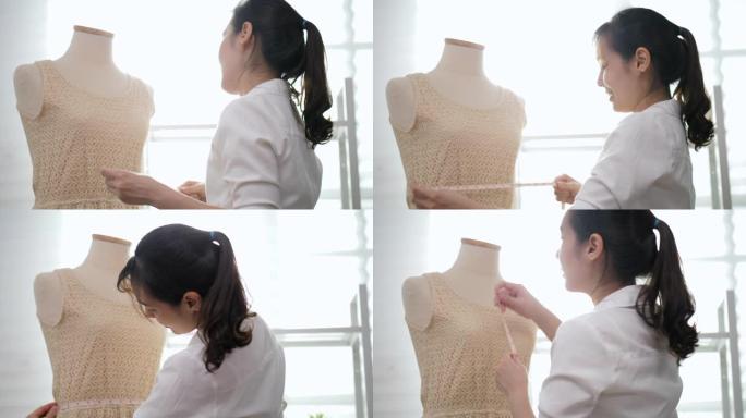 时装设计师在人体模型上使用卷尺