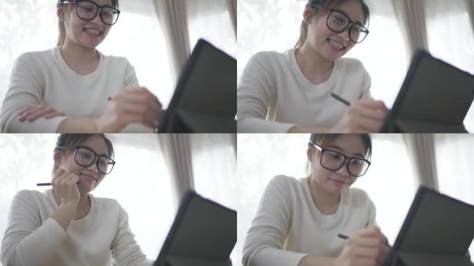 年轻女子在家在客厅放松，使用数字平板电脑