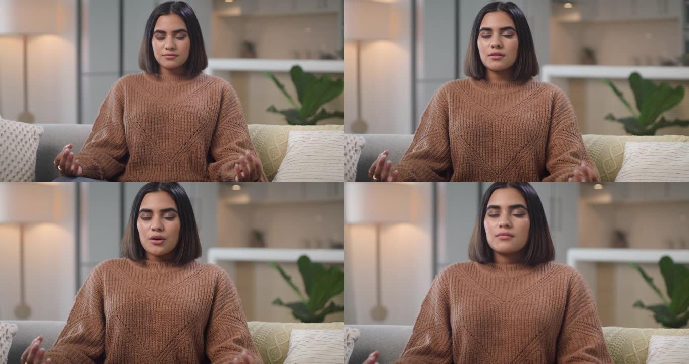 4k视频片段，一名年轻女子坐在家里冥想