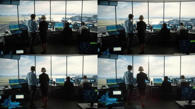 带着耳机的男女空中交通管制员在机场塔台交谈。办公室充满了台式计算机显示屏，带有导航屏幕，飞机出发和到