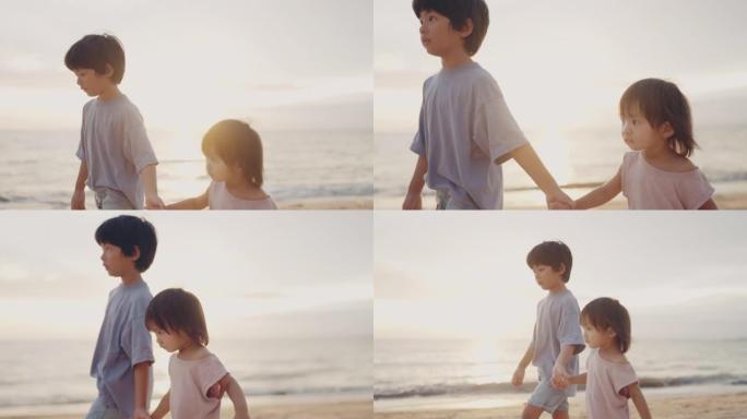 亚洲小男孩和女孩在海滩上玩耍。