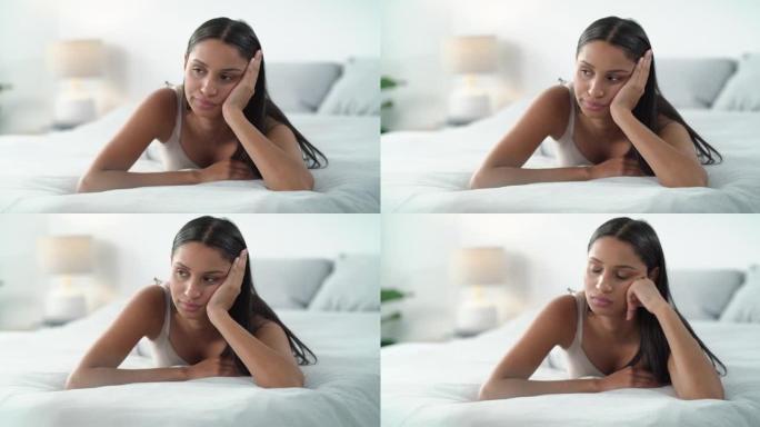 4k视频片段，一名年轻女子在家中床上感到不快乐