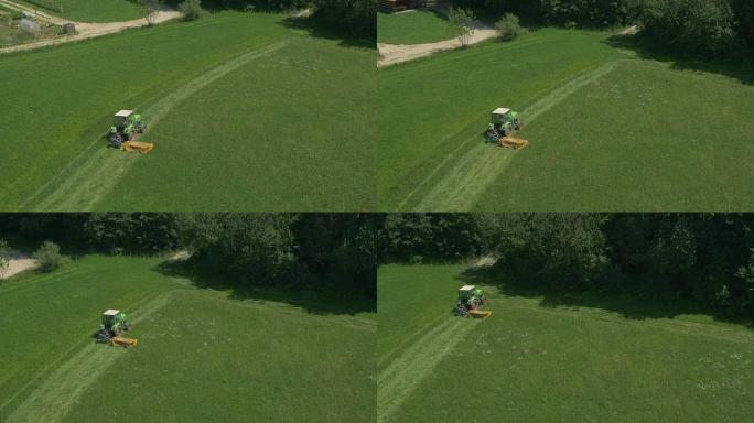 空中: 在草地上割草的拖拉机