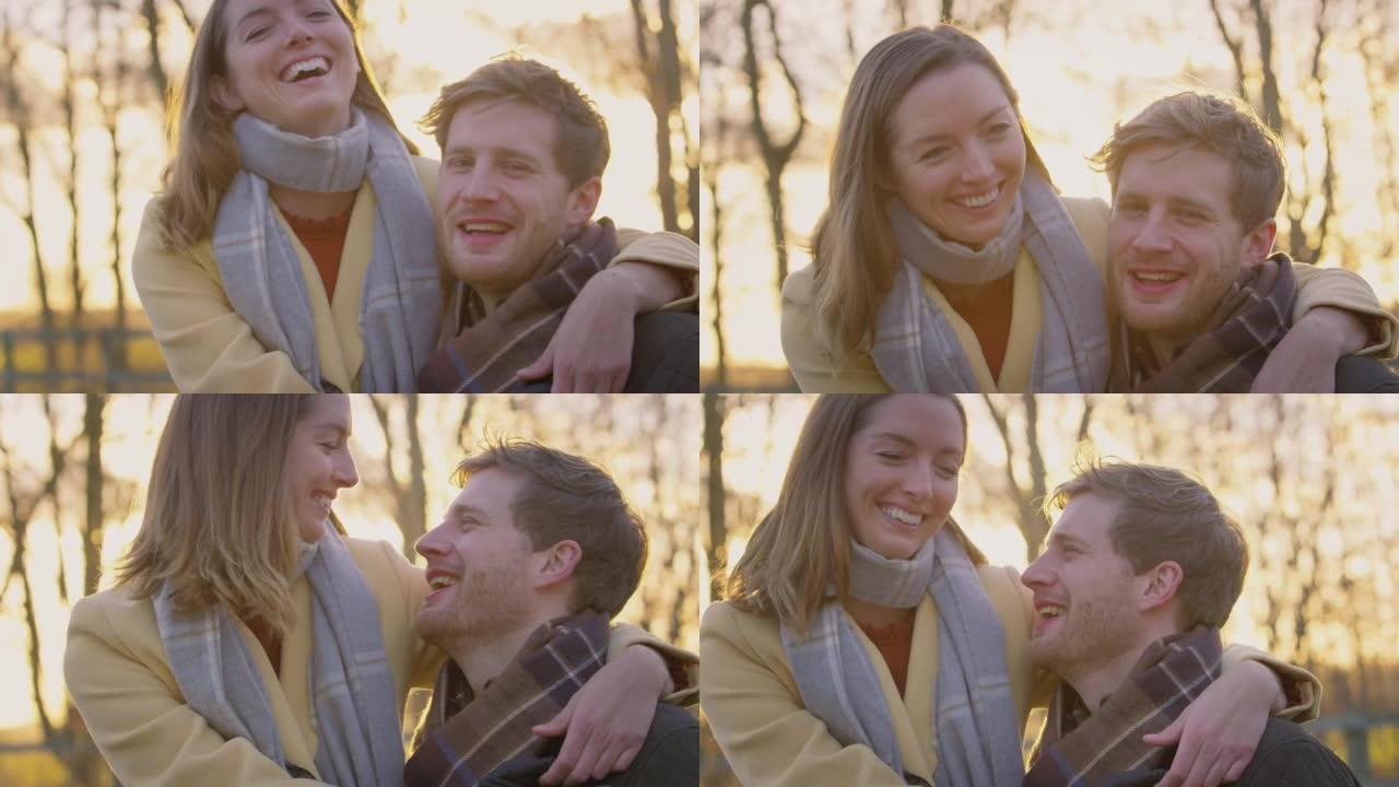 浪漫情侣在冬季或秋季乡村散步时拥抱的肖像 -- 慢动作拍摄
