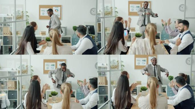 成功的非洲裔美国员工向团队做演讲，然后在办公室跳舞