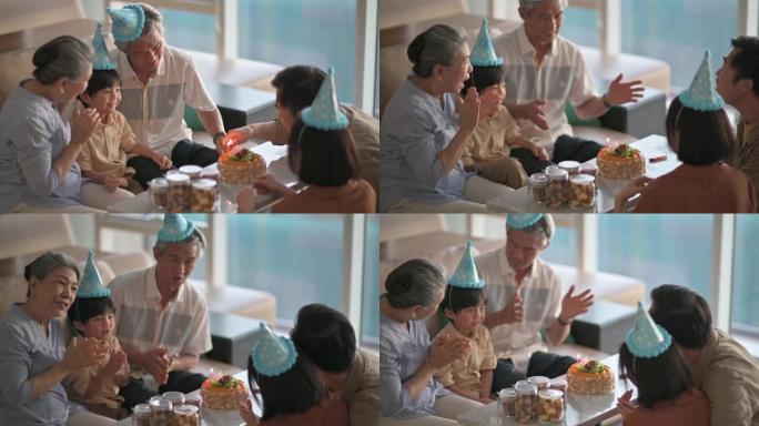 亚洲华人多代家庭拍手唱生日歌为6岁男孩在客厅庆祝生日