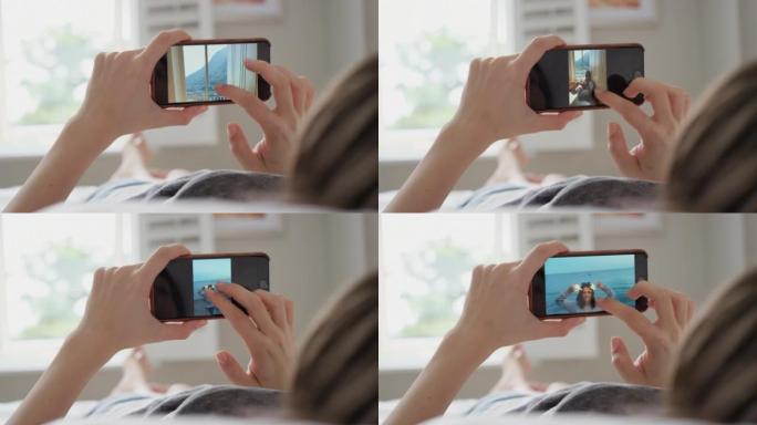 一个无法识别的女人使用智能手机浏览照片的4k视频片段