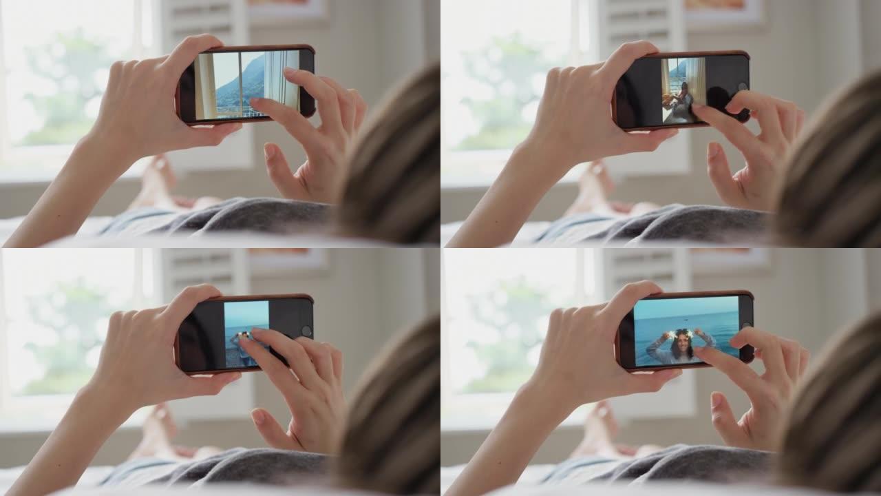 一个无法识别的女人使用智能手机浏览照片的4k视频片段