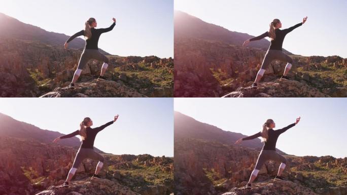 4k视频录像一名年轻女子在山上做瑜伽