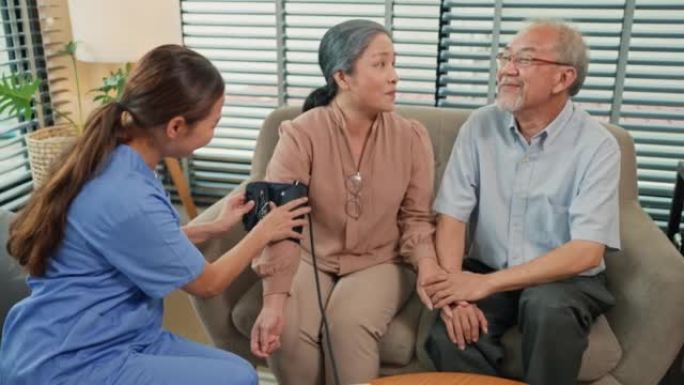 Asian elderly couple doing health check at home wi