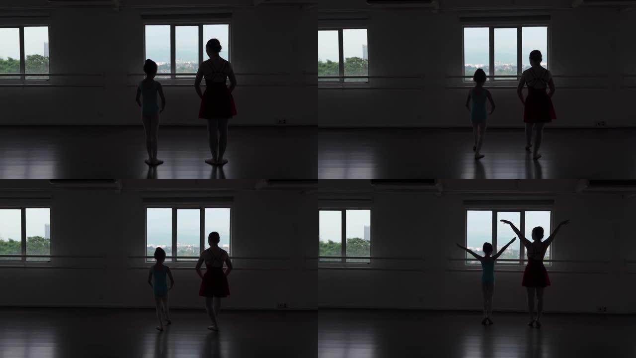 剪影亚洲中国少女芭蕾舞演员在工作室训练她的年轻女学生
