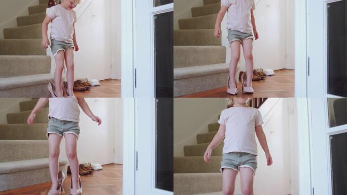 年轻女孩坐在楼梯上打扮，穿上母亲的高跟鞋走路