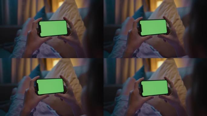 女人晚上使用手机绿屏