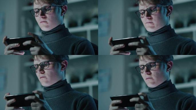 一个年轻的游戏玩家的电影镜头正在使用智能手机玩最新的创新技术视频游戏。