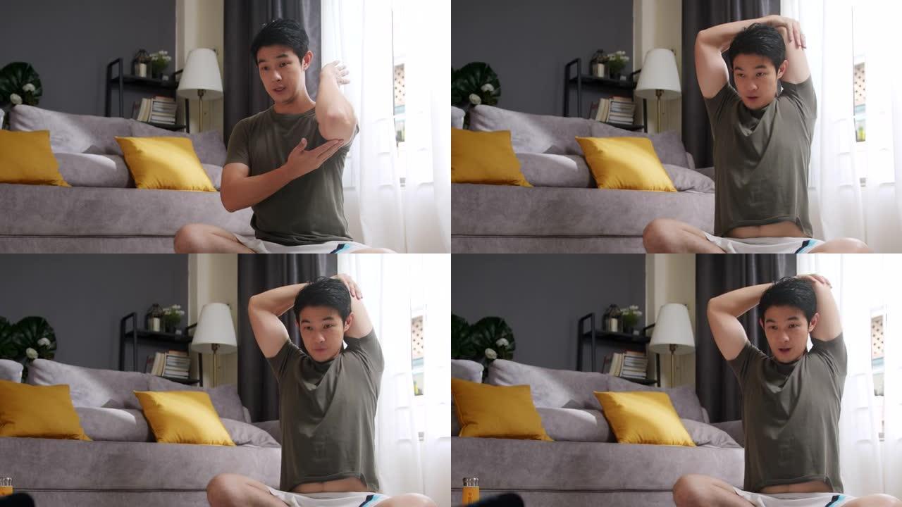 亚洲男子教授或指导将三头肌伸向在家锻炼的在线学生。Vlogger在社交媒体上为他的实时流媒体或vlo