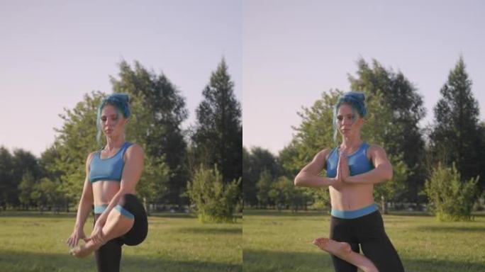 一个有吸引力的健身瑜伽老师的垂直视频，他穿着绿松石的瑜伽服装，穿着绿松石的头发，在公园的草地上做瑜伽