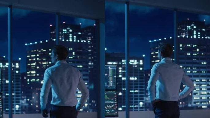 傍晚商人向窗外看的垂直肖像。享受成功生活的现代对冲基金投资者。城市景观，夜间有摩天大楼和霓虹灯