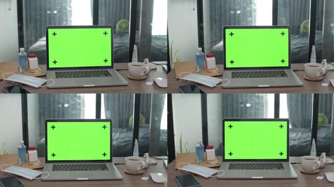 绿屏电脑笔记本电脑的平移镜头，没有人