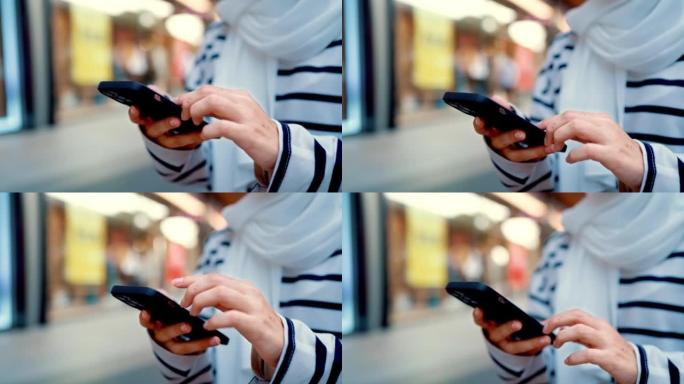 穆斯林妇女在购物休息时使用电话。