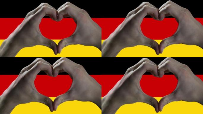 男人的手在德国国旗上做心脏标志。特写。