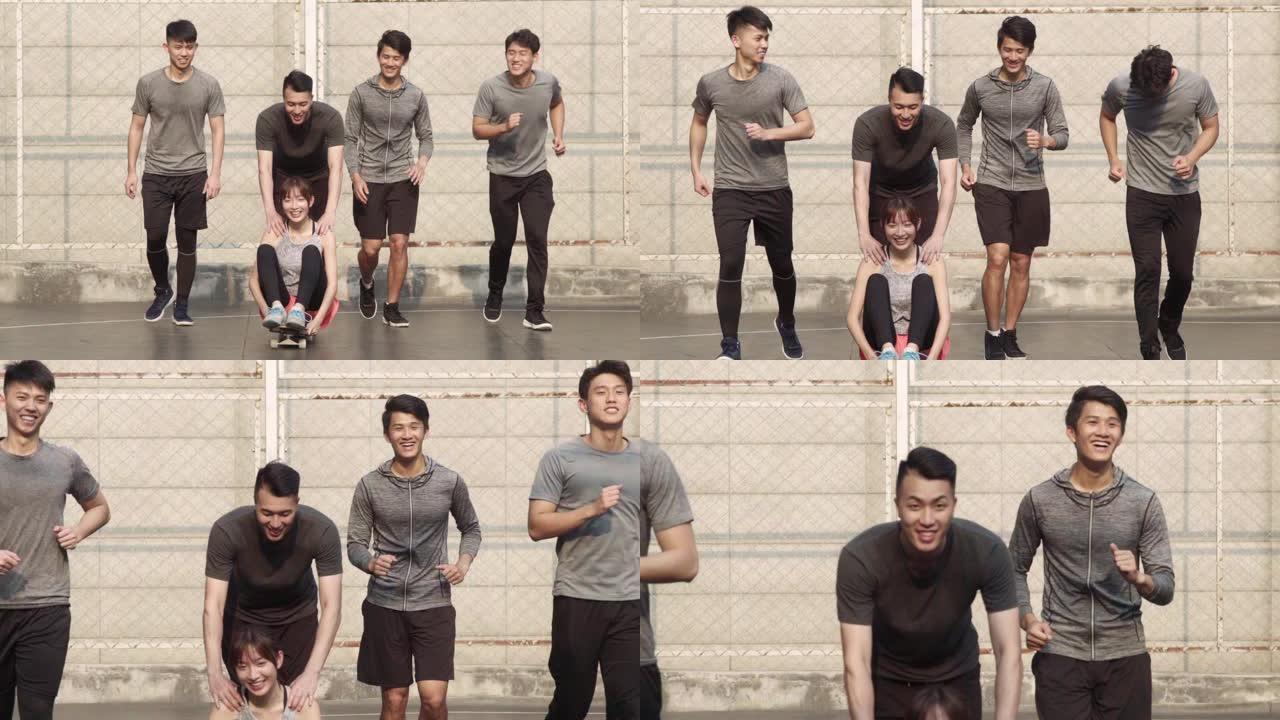 五名亚洲年轻人在室外篮球场上玩得开心